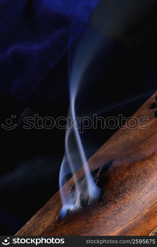 Close-up of smoke rising out of a wooden cylinder