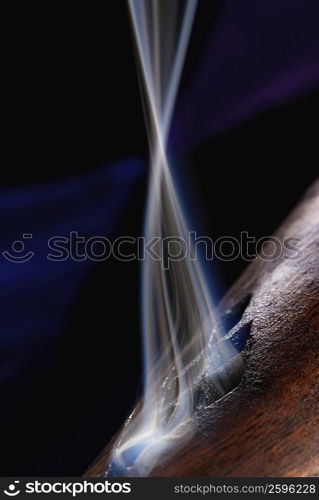 Close-up of smoke rising out of a wooden cylinder