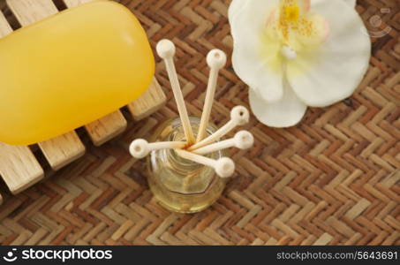 Close-up of soap , reed diffuser and orchid