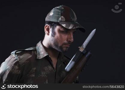 Close-up of soldier with gun
