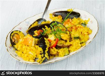 Close-up of Spanish paella on white plate