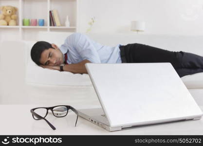 Close-up of spectacles and laptop