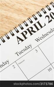 Close up of spiral bound calendar displaying month of April.