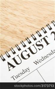 Close up of spiral bound calendar displaying month of August.