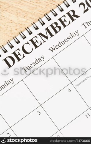 Close up of spiral bound calendar displaying month of December.