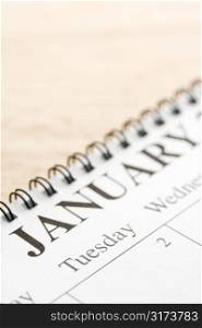 Close up of spiral bound calendar displaying month of January.
