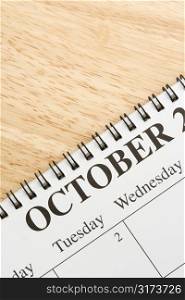 Close up of spiral bound calendar displaying month of October.