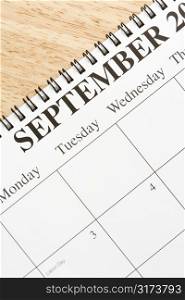 Close up of spiral bound calendar displaying month of September.