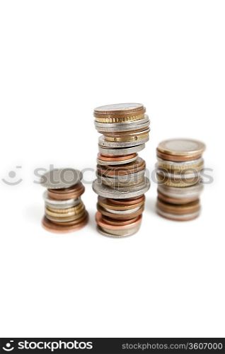 Close-up of stack of coins balancing over white background