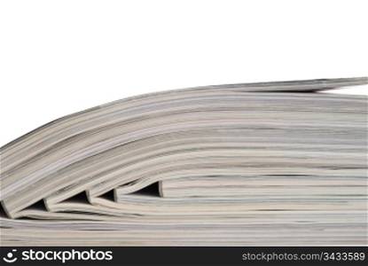 Close-up of stack of magazines on white background. Magazines