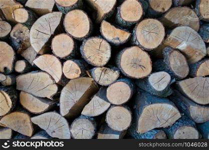 Close-up of stacked and prepared of chopped firewood. Firewood background texture. Beautiful firewood pile background with many wood