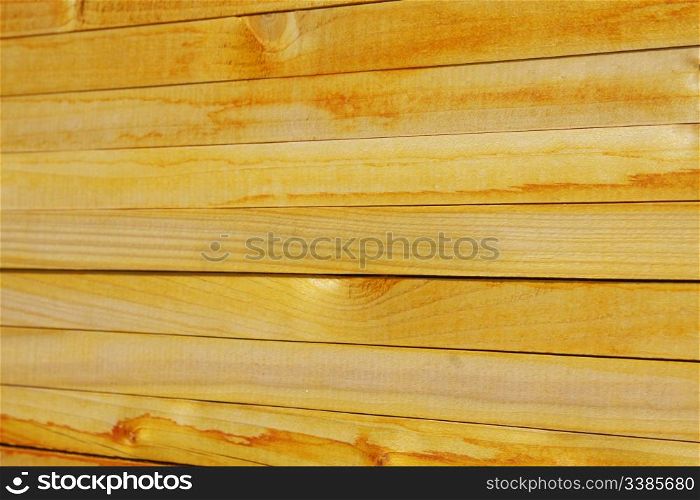 Close-up of stacked yellowish wooden planks