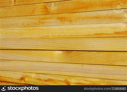 Close-up of stacked yellowish wooden planks