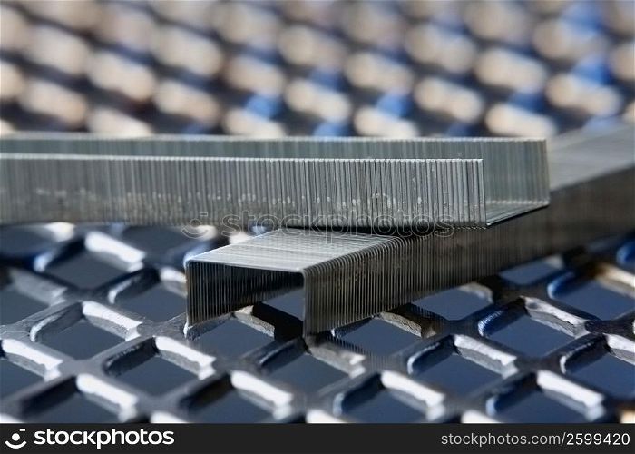 Close-up of staples on a metal grille