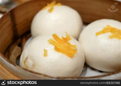 Close up of steamed egg yolk bun on table
