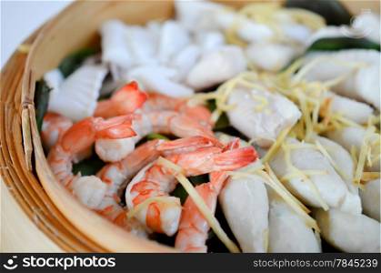 close-up of steamed seafood in a bamboo basket