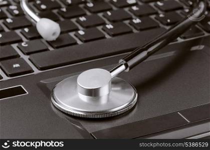 Close up of stethoscope on laptop keypad
