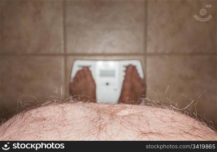 Close up of stomach of large hairy man standing on bathroom scales