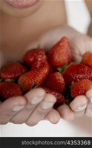 Close-up of strawberries in a young woman&acute;s hands