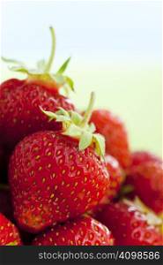 Close up of strawberries over light background