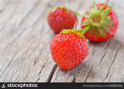 close up of strawberry on old wooden background