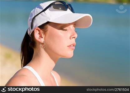 Close-up of summer active woman with cap enjoying sun