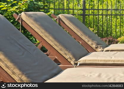 Close-up of sunbathing chairs in a row