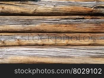 Close up of sunny old weathered log wall background