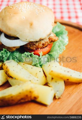 Close up of tasty burger on wooden tray