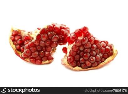 close up of tasty pomegranate fruit on white background