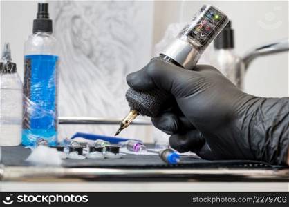 Close up of tattoo artist tools and workplace. High quality photo.. Close up of tattoo artist tools and workplace