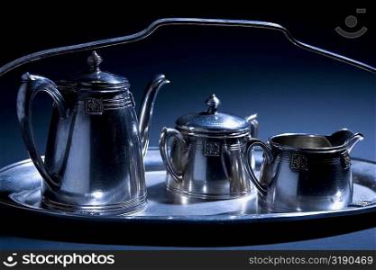 Close-up of tea kettles on a serving tray