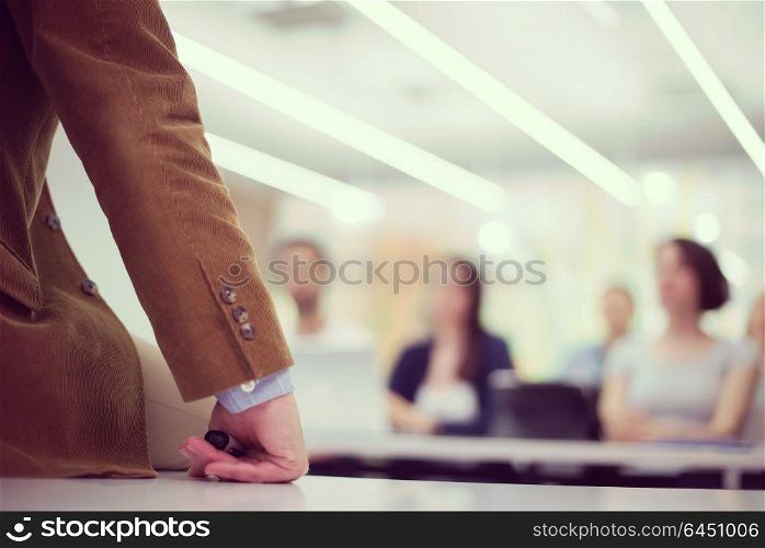 close up of teacher hand with marker while teaching lessons in school classroom to students