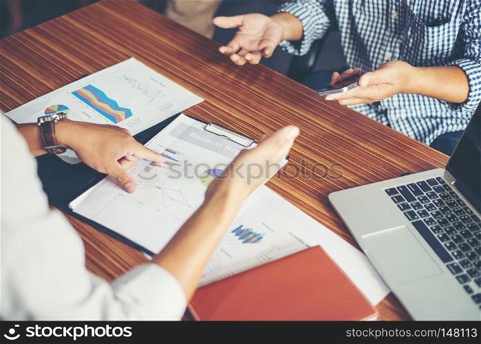 Close-up of  Team Business people discussing a financial plan at office.. Close-up of  Team Business people discussing a financial plan at