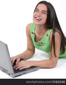 Close Up Of Teen Laughing And Working On Computer With Gum In Mouth.