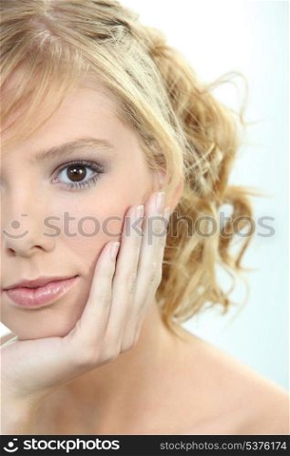 close up of teenage blonde&rsquo;s face partially hidden