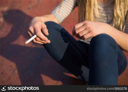Close Up Of Teenage Girl Smoking Cigarette Outdoors
