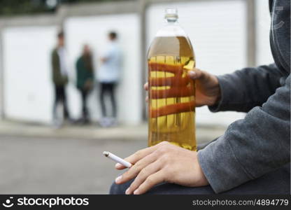 Close Up Of Teenager Drinking Alcohol And Smoking