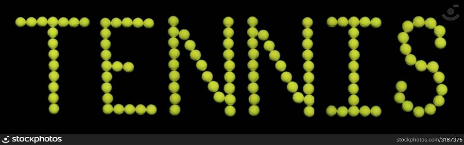Close-up of tennis balls spelling the word tennis