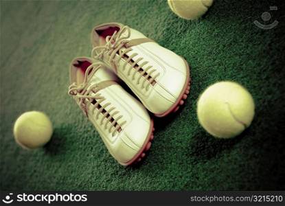 Close-up of tennis shoes with tennis balls