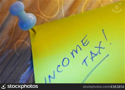 Close-up of text Income Tax written on an adhesive note