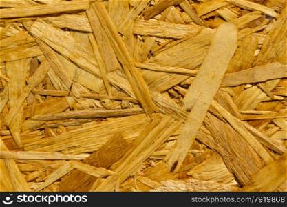 Close up of texture and pattern of Oriented Strand Board, a wooden panel. Texture or background.