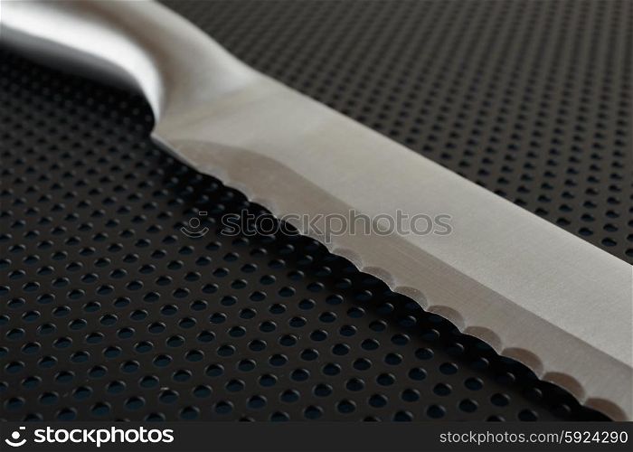 Close up of the blade of stainless steel bread knife