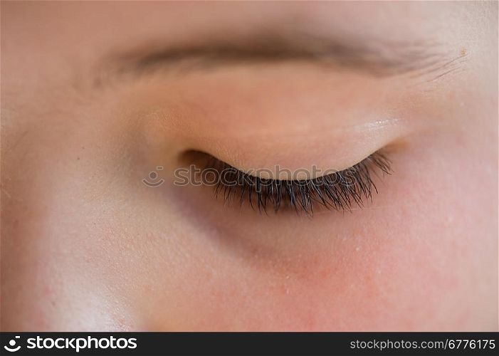 Close-up of the closed eye of a girl