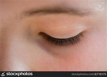 Close-up of the closed eye of a girl