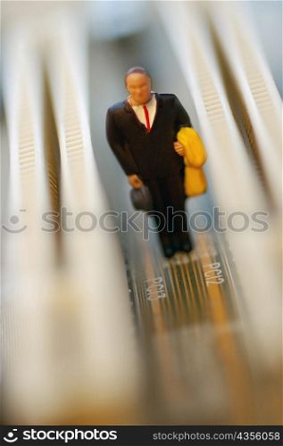 Close-up of the figurine of a businessman on a circuit board