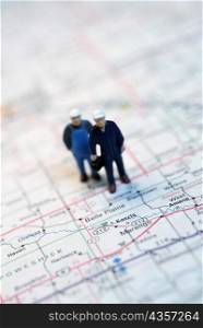 Close-up of the figurines of two construction workers on a map