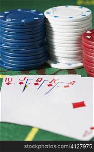 Close-up of the poker of diamonds with stacks of gambling chips on a gambling table