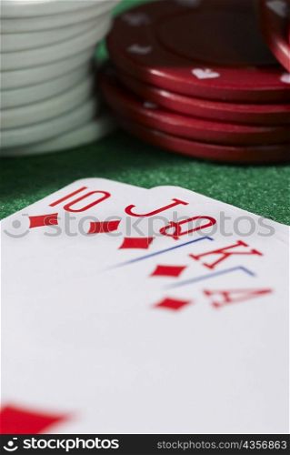 Close-up of the poker of diamonds with stacks of gambling chips on a gambling table