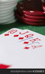 Close-up of the poker of diamonds with stacks of gambling chips on a gambling table